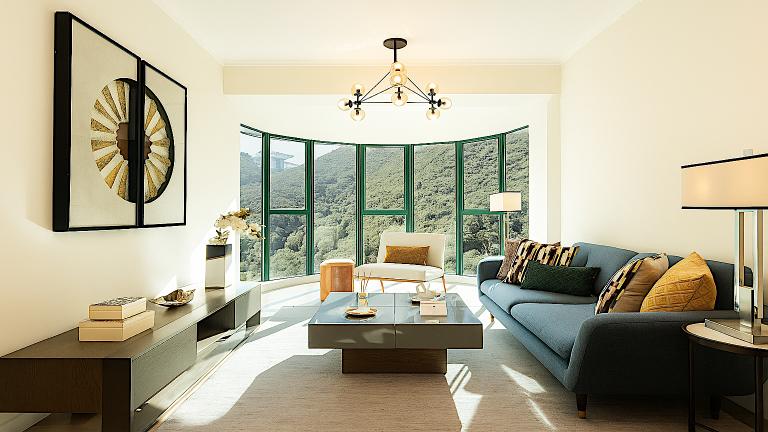 Modern luxury apartment living room with panoramic green hill views.