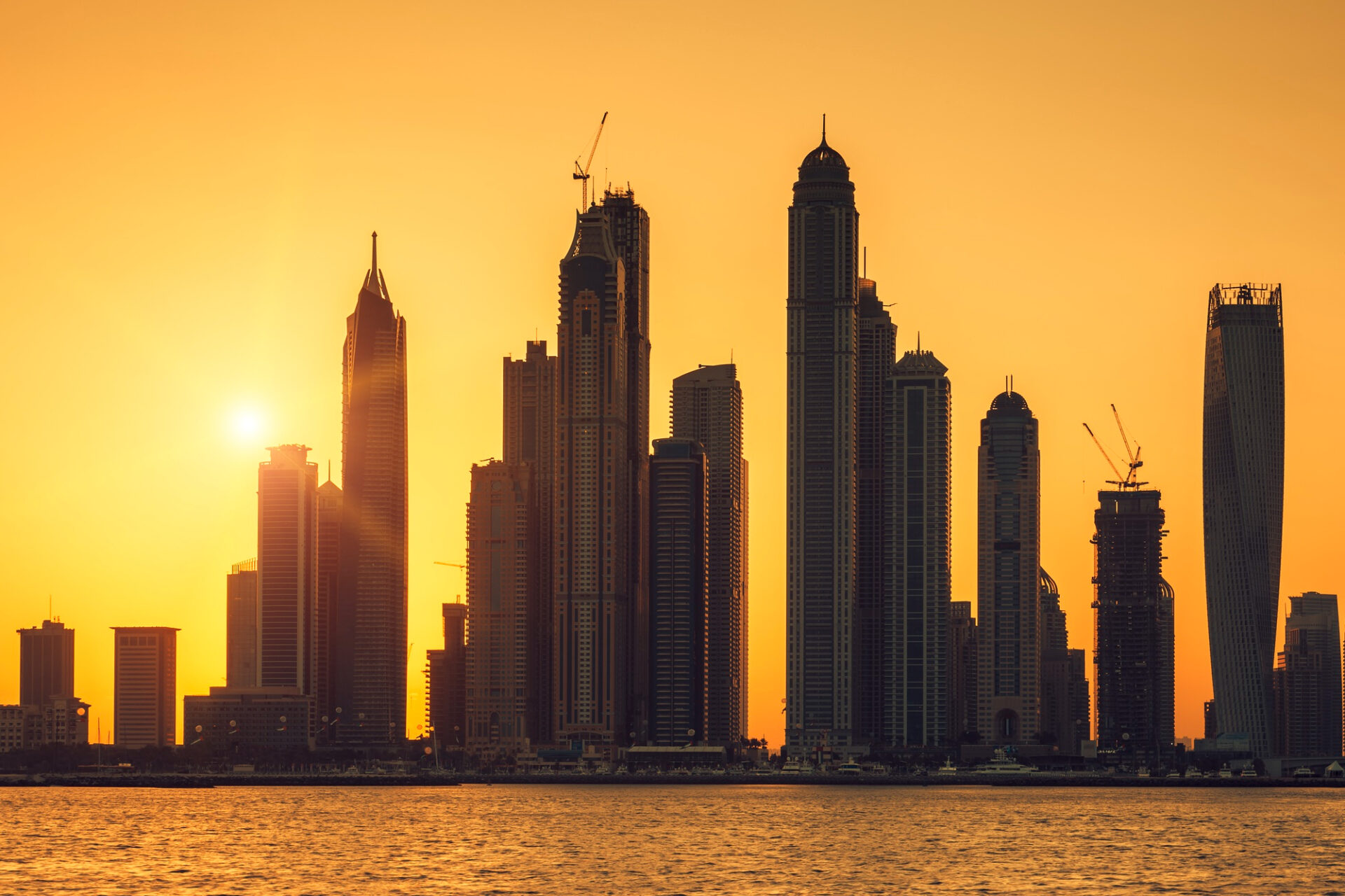 Dubai real estate skyline at sunset highlighting prime investment destinations