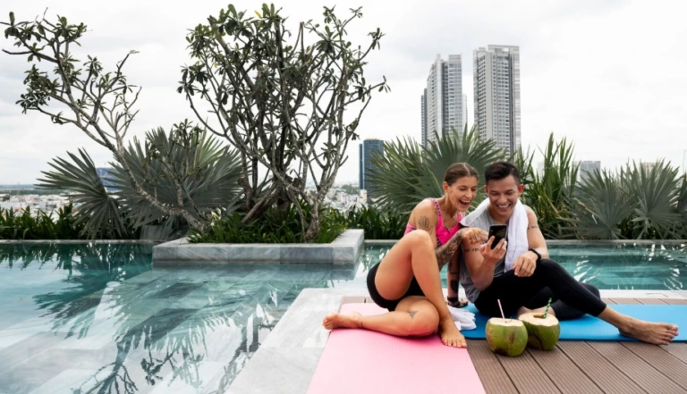 Couple relaxing after yoga by rooftop pool in a wellness luxury home Singapore