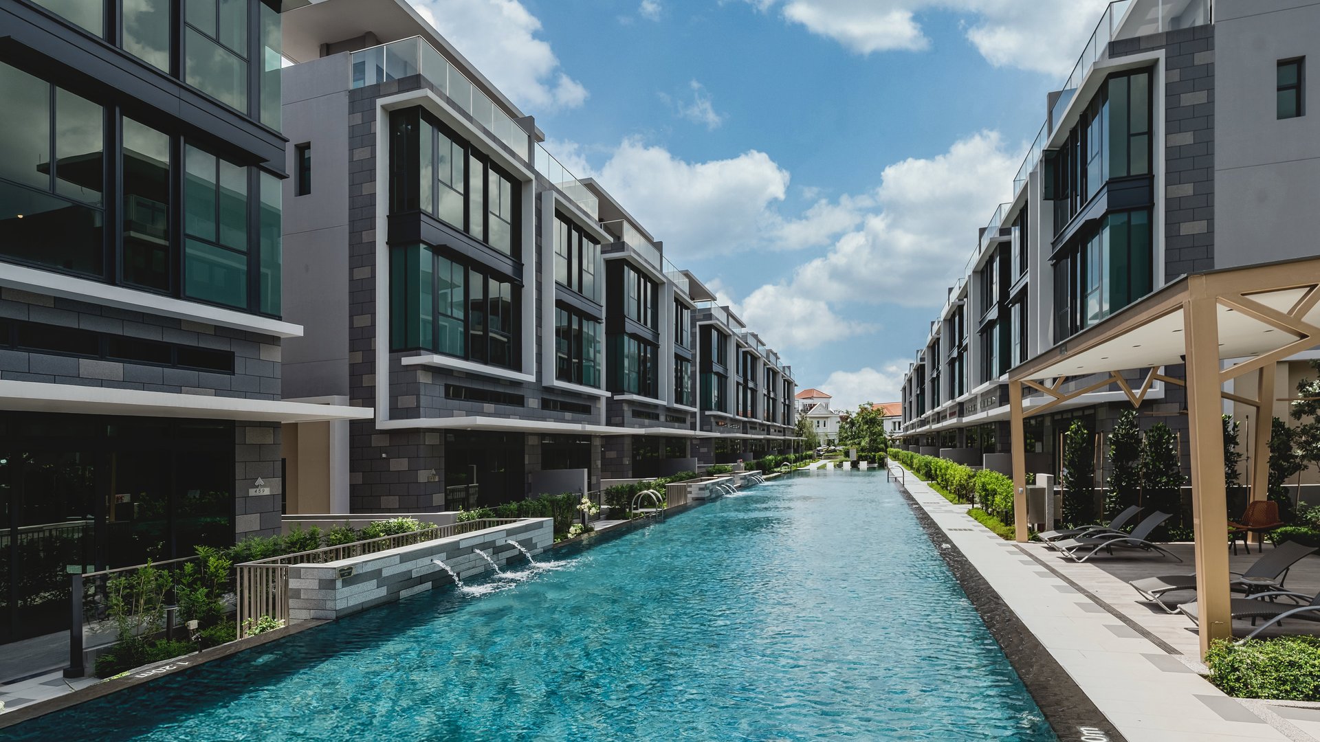 50 m lap pool lined by three-storey strata semi-detached houses at Belgravia Ace, Belgravia Drive, District 28