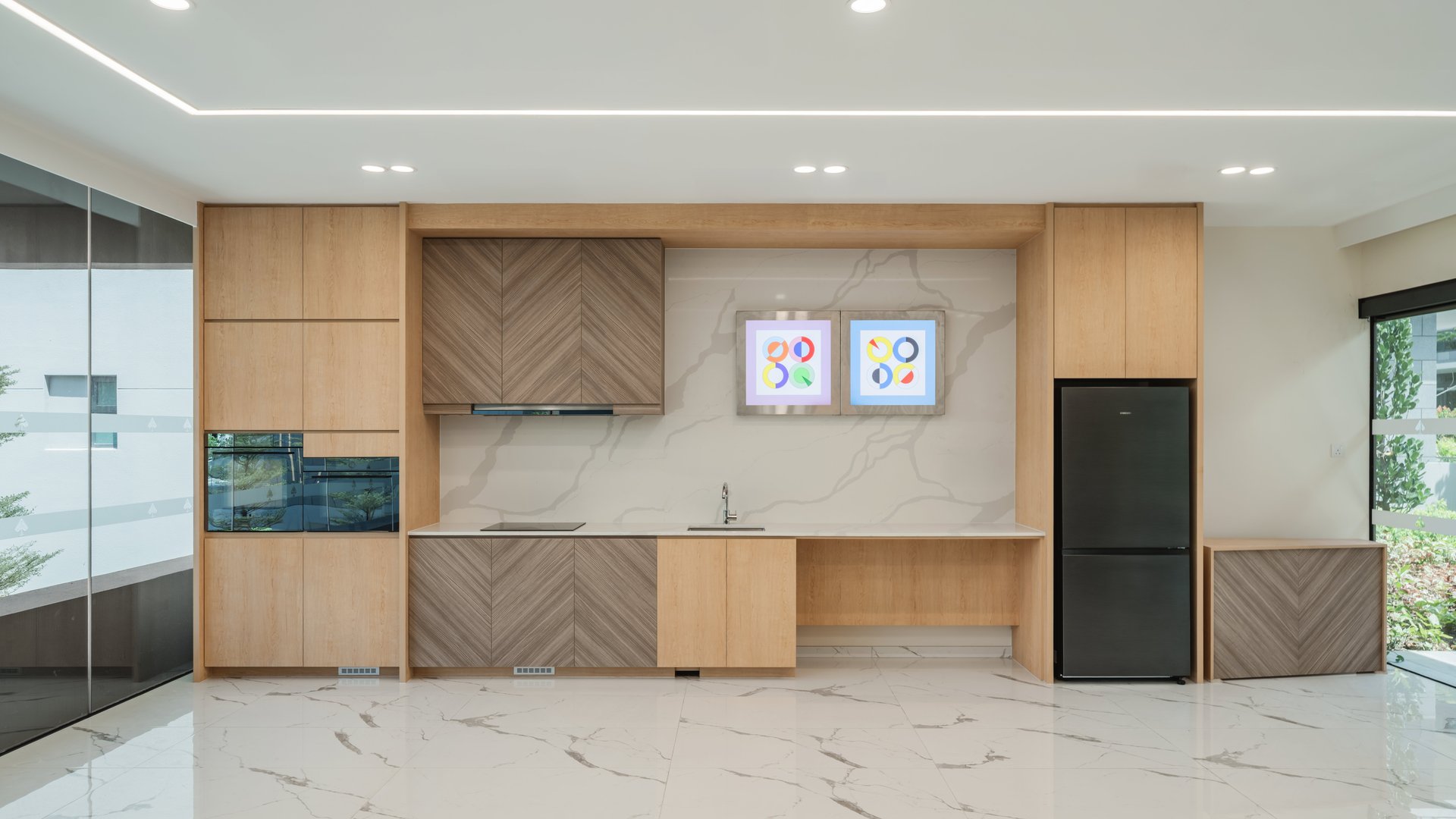 Clubhouse function room with timber pantry cabinets, oven, sink and fridge at Belgravia Ace